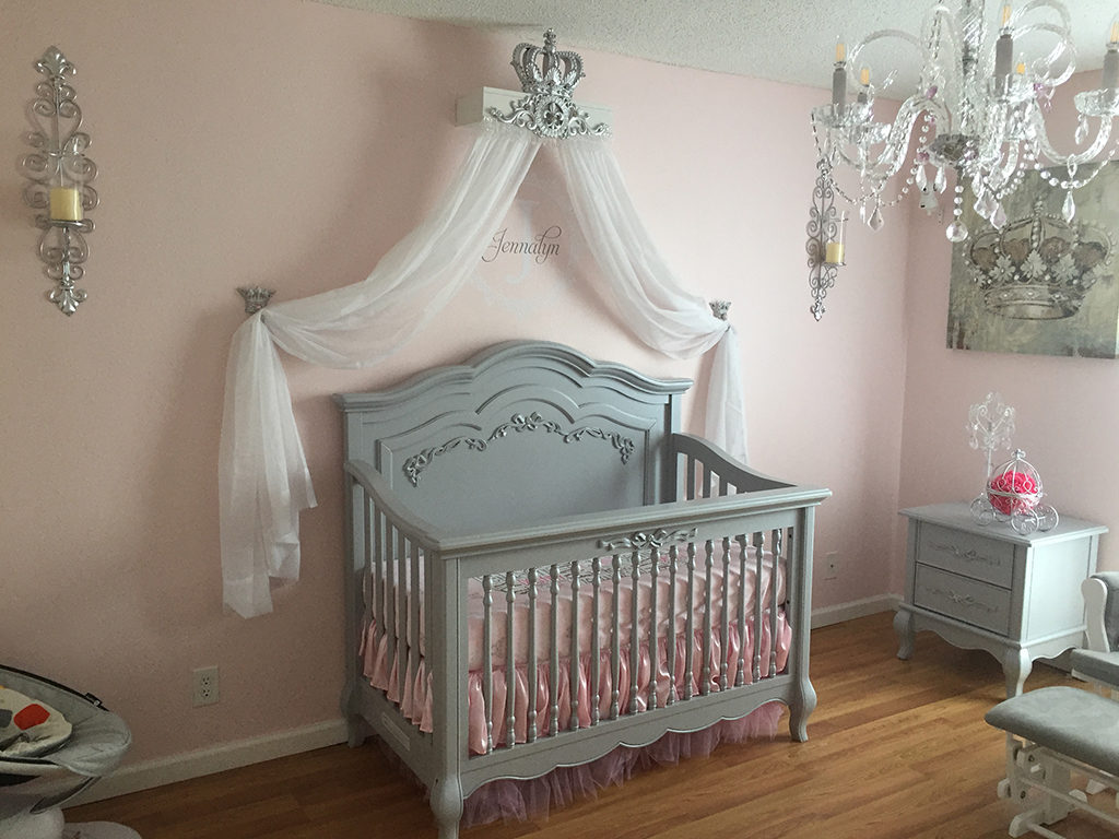 A crown canopy adds a touch of royalty to this gray and pink nursery