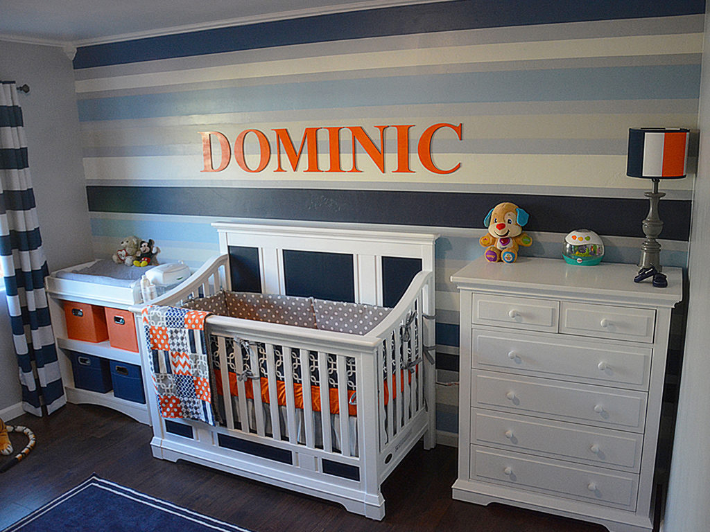 Pops of orange brighten up this blue and white nursery